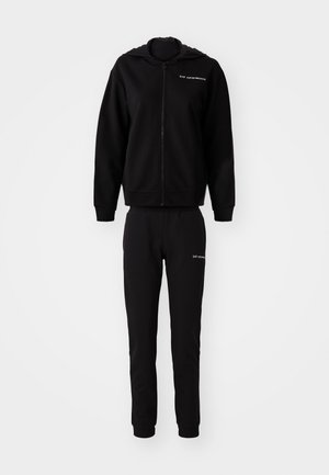 Zwarte sweatshirt en bijpassende joggers, gemaakt van zachte stof. Hoodie met ritssluiting, elastische manchetten en tailleband. Logo gedrukt op beide stukken.