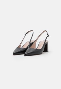 Black leather slingback heels with a pointed toe, a clear side, and a block heel. Includes a silver-tone adjustable strap detail.