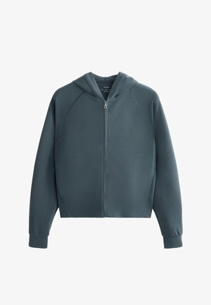 Zipsová mikina s kapucňou v tmavom teal odtieni, textúrovaná tkanina s ryhovaným vzorom, raglánové rukávy a manžety. Obsahuje predné zapínanie na zips.