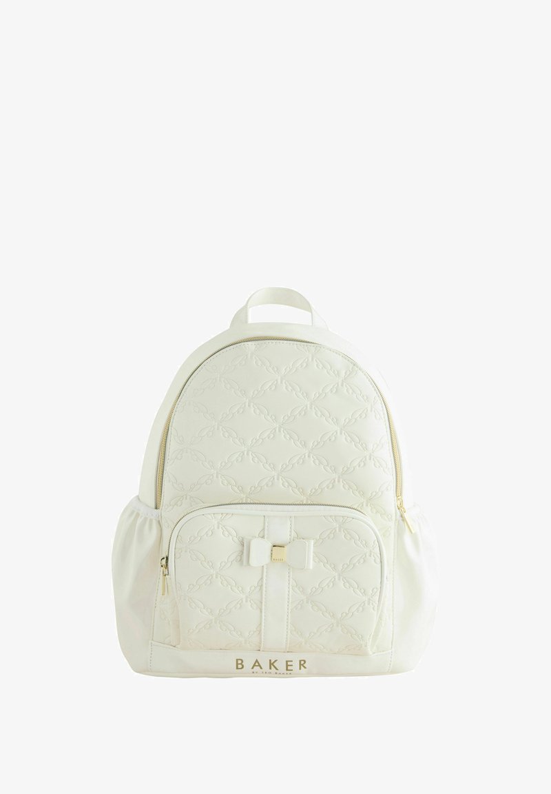 White backpack with quilted design, gold hardware, a front pocket with bow accent, and the brand name "BAKER" at the base.