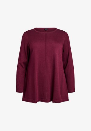 Jersey burdeos de manga larga con cuello redondo, que presenta un detalle de costura central y un bajo ligeramente acampanado. Material de punto suave y texturizado.