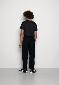 Jordan WARMUP PANT - Calças de fato de treino - black