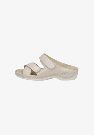 Beige open-toe slide sandal made of textured material, featuring two adjustable Velcro straps and a white cushioned sole.