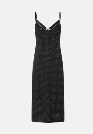 Vestido negro con tirantes finos, adornado con lunares blancos en toda su superficie. Diseño en forma de V con un pequeño lazo en el busto. Tejido de textura suave.