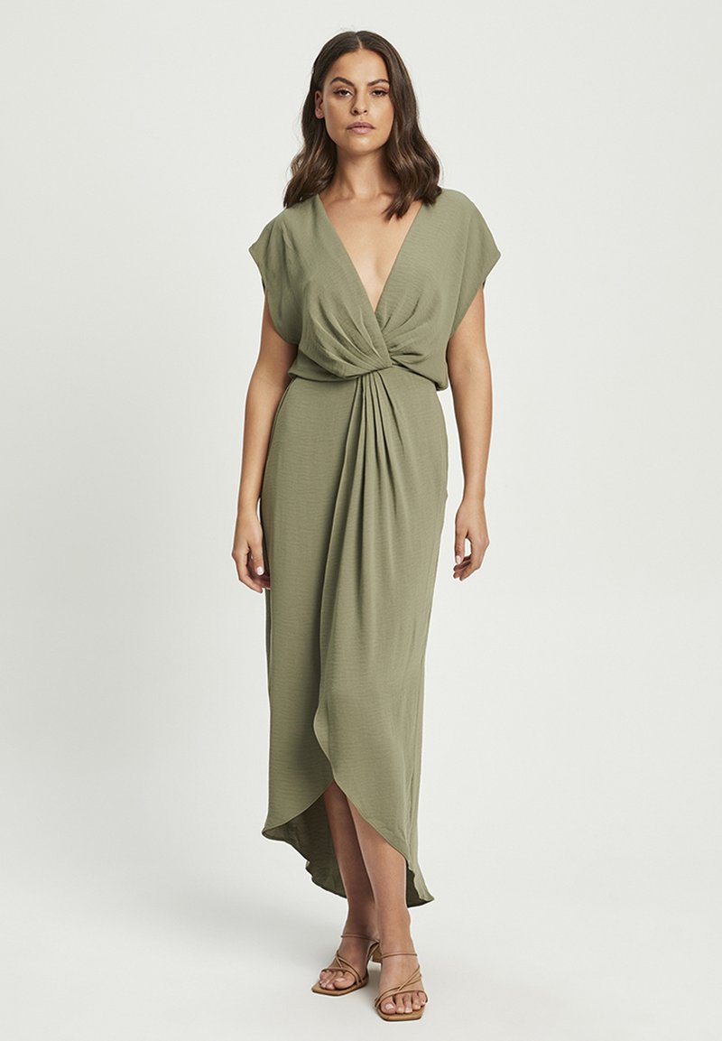 Olive green dress with a deep v-neck and short flutter sleeves, featuring a twisted waist detail and an asymmetrical hemline.