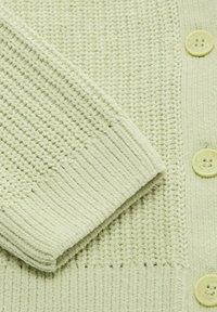 Cardigan lavorato a maglia verde chiaro con motivi a coste testurizzati, finitura liscia e quattro bottoni arrotondati.
