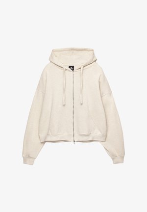 Krém színű, cipzáras kapucnis pulóver, húzózsinóros kapucnival, oversized fazonnal és elülső kenguruzsebbel. Puha, textúrált anyagból készült.