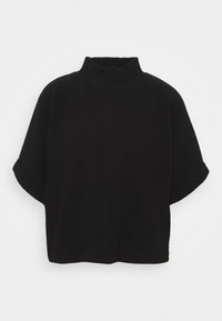 Svart kortärmad topp med hög, ribbad turtleneck-design. Har en avslappnad passform och textilstruktur. Inga synliga mönster eller accenter.