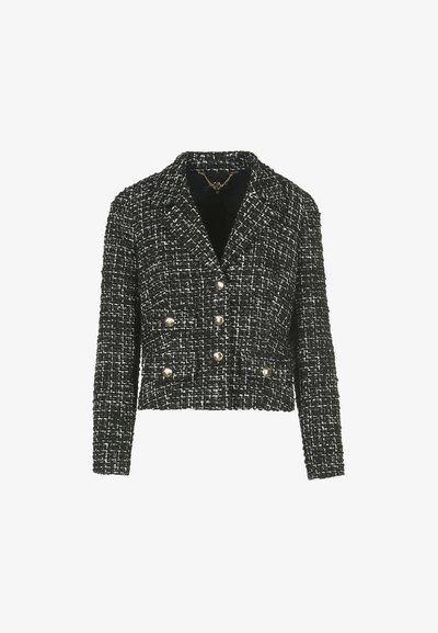 Fekete-fehér tweed zakó, crop fazonban, dupla gombolású elülső résszel, arany tónusú gombokkal és levágott gallérral. Texturált szövetfelület.