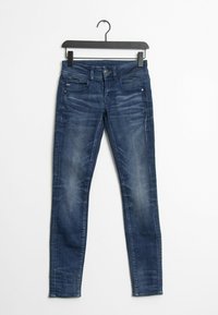 Smaljeans i mörkblå denim, med midjehög midja, fem fickor, lätt blekning och en slät, texturerad yta.
