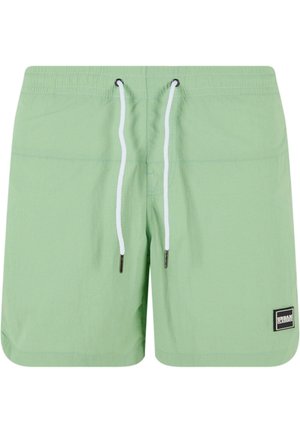 Light green swim shorts made of lightweight fabric, featuring a drawstring waist with white cords and a small black brand logo patch.