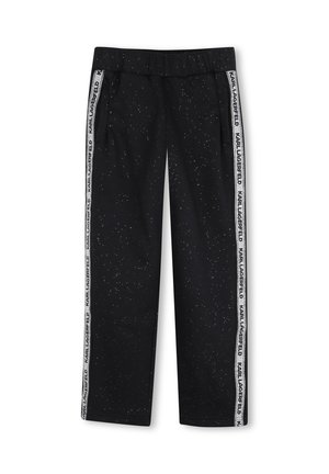 Pantalon noir avec motif moucheté blanc et bandes latérales blanches affichant le texte répété "KARL LAGERFELD".