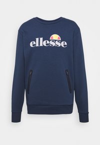 Sweat-shirt bleu marine à manches longues, col rond, avec deux poches latérales zippées ; présente un logo imprimé en blanc avec un accent coloré.