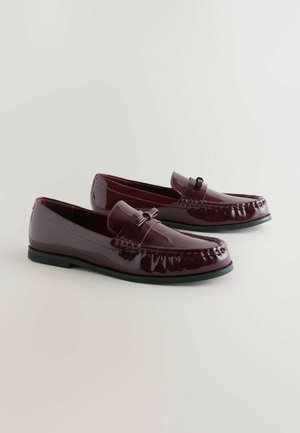 Burgundy patent leather loafers with a rounded toe, decorative strap, and subtle stitching detail. Black rubber sole.
