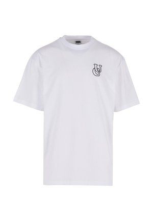 Balta medvilninė marškinė su apykakle, trumpomis rankovėmis ir mažu juodu logotipu kairėje krūtinės pusėje. Lygus paviršius.