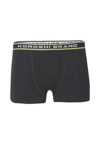 Melni bokseršorti ar zaļu un baltu elastīgu jostu, uz kuras rakstīts "KOROSHI BRAND." Iezīmē ciešu piegulšanu un gludu kokvilnas tekstūru.