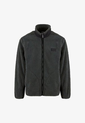 Tumes hallides fleecest jope, millel on täispikk tõmblukk, kõrge krae ja mustad detailid. Tekstureeritud pind ning mähe vasakul rinnal.