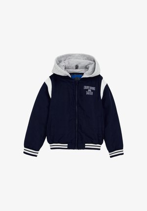 Marineblå lynlåsjakke med hvide striber på ærmer og manchetter, grå fastmonteret hætte og teksten "Blue Ridge est. 1986" på brystet.