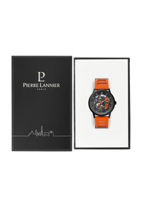 Sort ur med orange silikonerem og skelet-urskive. Leveres i en sort æske med sølvlogo og en skyline-grafik på forsiden.