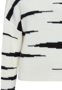 Knit sweater in cream with black abstract stripes. Features a relaxed fit, dropped shoulders, and ribbed cuffs and hem.