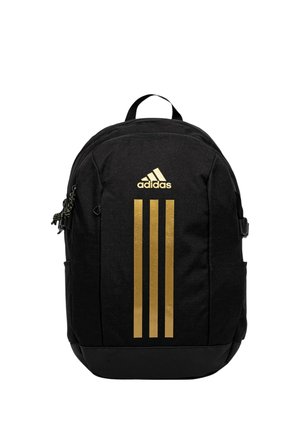 Zaino nero Adidas con logo dorato e tre strisce dorate verticali sul davanti, tasche con cerniera e maniglia superiore.