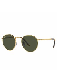 Occhiali da sole rotondi con montatura in metallo dorato, lenti verde scuro, ponte del naso trasparente e aste nere con punta, caratterizzate da un design testurizzato.