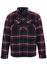 Punane ja must ruuduline flanellpait, millel on krae, kaks rinnaTaskut, nööbid ees ja pikad varrukad. Pehme tekstuur ja silmapaistev ruuduline muster.