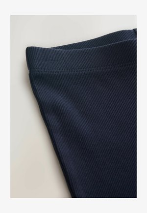 Legging in tessuto a coste blu navy con vita elastica liscia. La texture è strutturata, offrendo un aspetto aderente. Senza motivi o dettagli visibili.