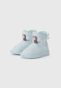 Stivaletti alla caviglia azzurro chiaro realizzati in materiale morbido, con personaggi illustrati sui lati e un fiocco decorativo sul retro.