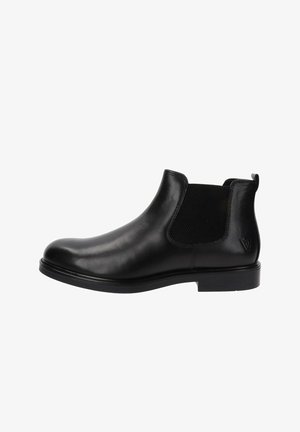 Botas Chelsea de cuero negro con paneles elásticos en los lados, puntera redondeada, diseño minimalista y una textura suave. Suela de goma plana, sin herrajes visibles.