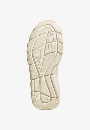 Sandal sole with beige rubber tread featuring geometric patterns and grooves for traction and flexibility, shown from the bottom.