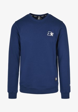 Mørkeblå sweatshirt lavet af blødt stof, med rund halsudskæring, ribbede manchetter, og et hvidt logo på brystet og ærmet.
