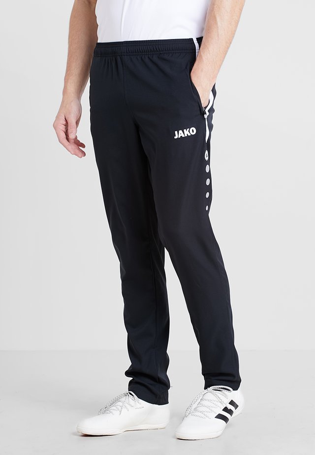 STRIKER - Tracksuit bottoms - schwarz/weiß