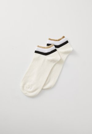 Cotton ankle socks in off-white with a textured golden tan and black striped ribbed cuff. Smooth finish, with a rounded toe design.