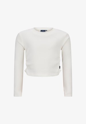 Top corto a maniche lunghe bianco a costine con scollatura rotonda e spacchi laterali. Presenta un'etichetta sul lato sinistro vicino all'orlo.
