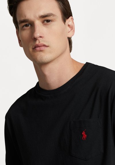 Black crew-neck t-shirt in cotton, featuring a front pocket and embroidered red logo. Smooth texture, simple design, and classic fit.