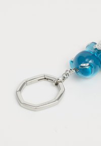 Blue crystal bear keychain with silver-toned octagonal metal ring and chain, featuring a shiny finish and decorative accents.