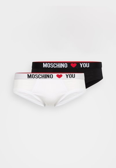 Two pairs of women’s underwear, one white and one black, with elastic waistbands featuring "MOSCHINO ❤️ YOU" in bold black and white text.