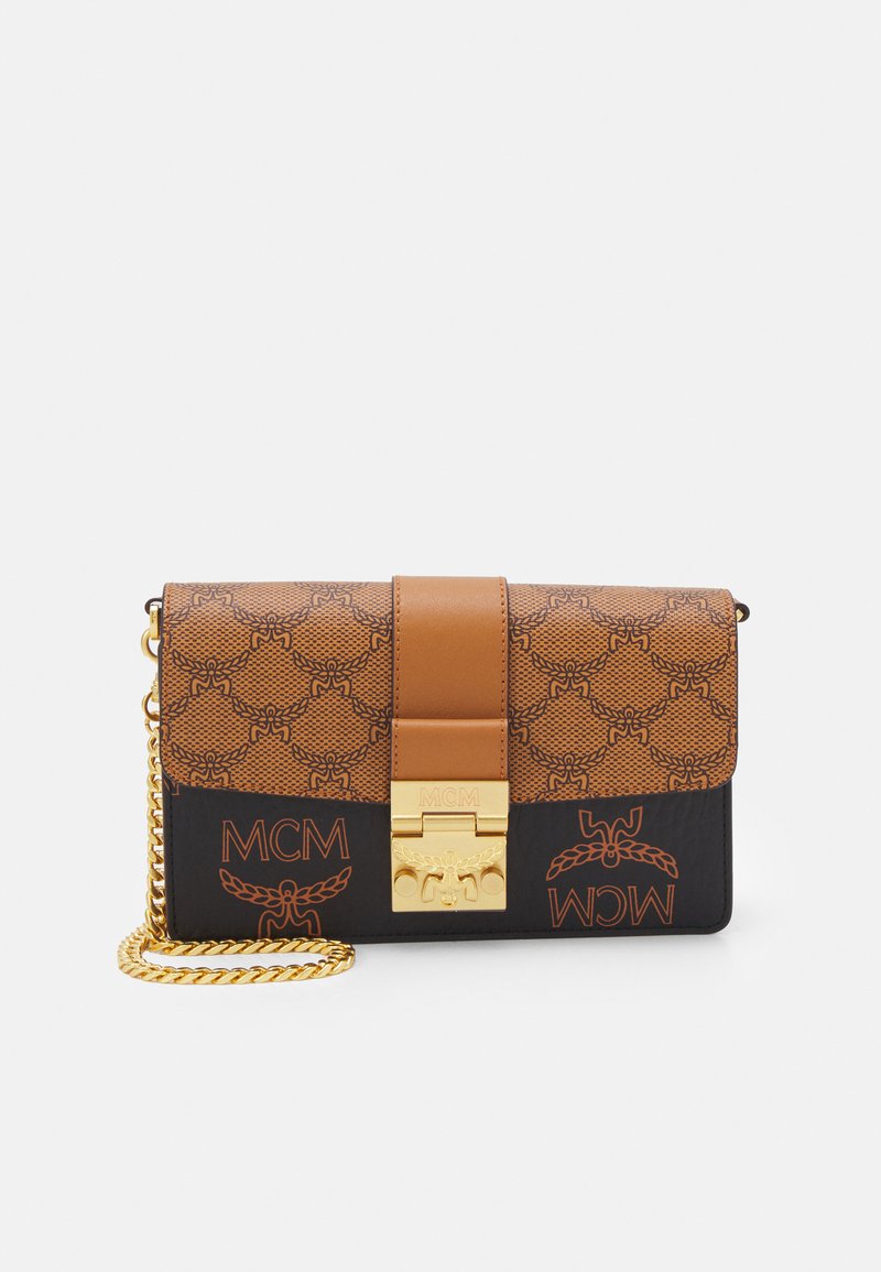 Brown and black leather crossbody bag with gold hardware, featuring MCM logo and textured pattern on the flap and front panel. Chain strap.