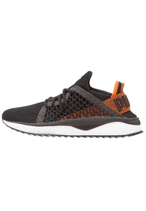 Black and orange mesh sneaker with white sole, lace-up design, and textured pattern on the side and heel tab.