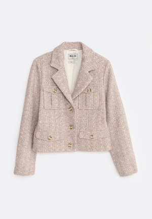 Korte jas van een wollen mix in lichtbeige met een visgraatpatroon. Beschikt over een dubbele knoopsluiting, twee voorzakken en gouden knopen.