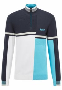 Tröja med halv dragkedja. Har färgblock i marinblått, vitt och ljusblått. Tillverkad av texturerat tyg med randiga detaljer.