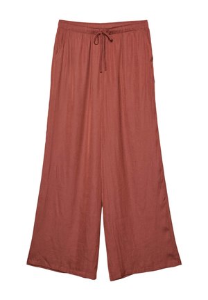 Pantaloni a gamba larga di colore ruggine, realizzati in tessuto morbido. Caratterizzati da una vita elastica con cordoncino e due tasche laterali.