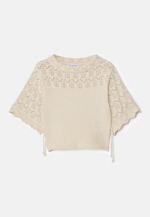 Maglietta a maniche corte lavorata a maglia in beige chiaro con un corpo testurizzato, motivo a occhio di pernice e dettagli con cordoncino all'orlo. Materiale morbido e traspirante.