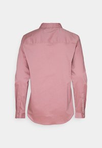 Long-sleeve shirt in soft pink fabric with a button-down collar, featuring a straight hem and single-button cuffs. Back view.