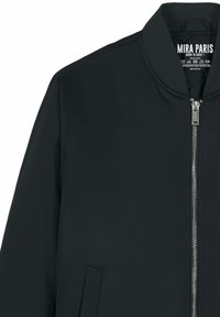 Schwarze Bomberjacke mit silbernem Frontreißverschluss, geripptem Kragen und Fronttasche; Etikett im Kragen innen mit der Aufschrift "MIRA PARIS BORN TO ROCK".