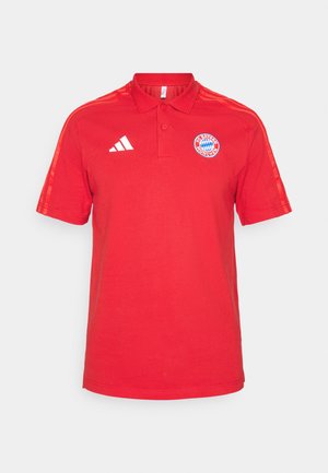 Red cotton polo shirt with a collar, short sleeves, three white stripes on the shoulders, and Bayern Munich logo on the chest.