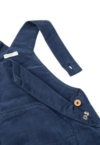 Námořnické manšestrové overalové kalhoty s nastavovacími ramínky, vybavené knoflíkem s květinovým vzorem a stříbrným kovovým hardwarem po straně.