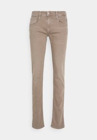 Beige raka jeans tillverkade av bomullsblandat tyg. Har fem fickor, bälteshällor och subtila sömsdetaljer längs sömmarna.