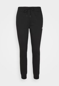 Schwarze Jogginghose mit schmal zulaufender Passform, elastischem Bund mit Kordelzug und kleinem Logo, das auf den linken Oberschenkel gestickt ist.